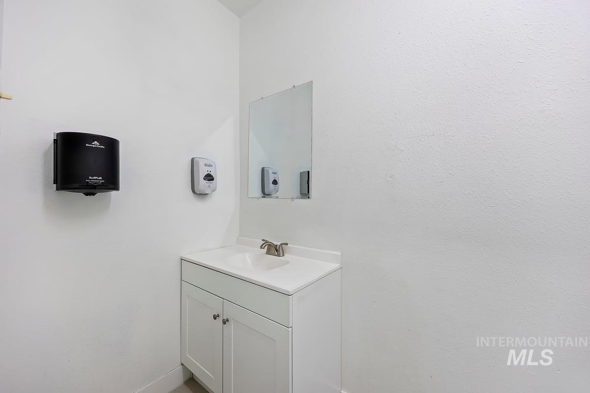 Bathroom with vanity and baseboards