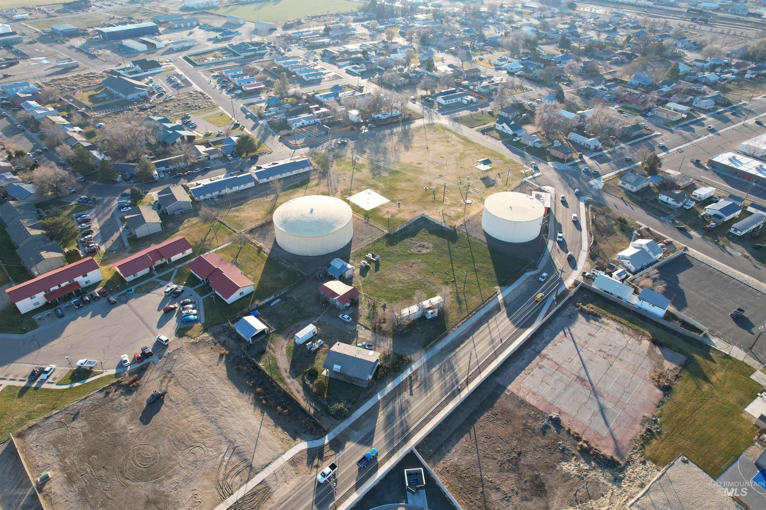 Aerial view of property and surrounding area with industrial structures