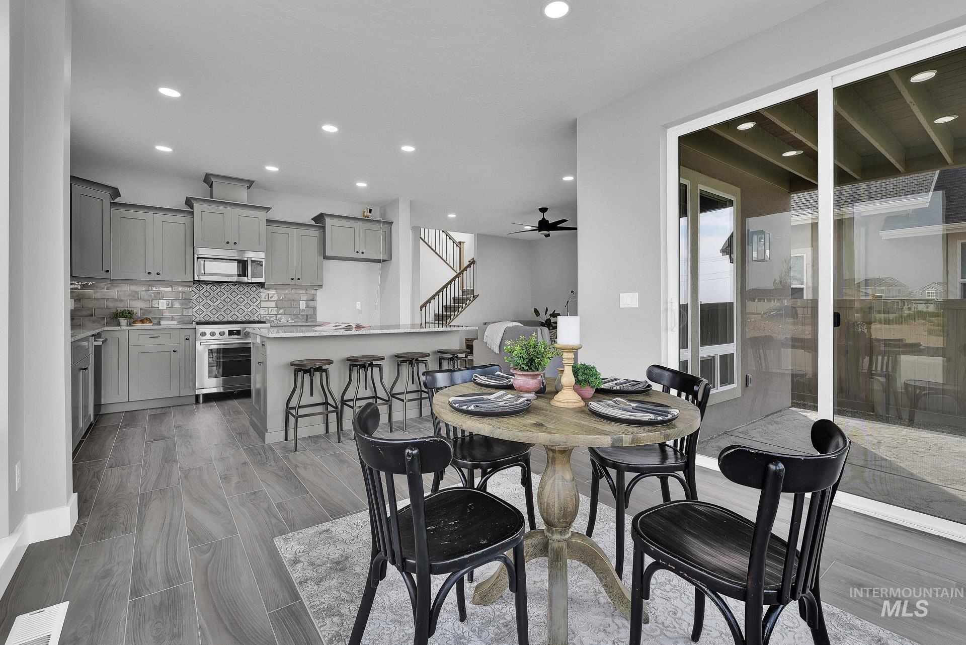 Dining room featuring stairway, recessed lighting, light wood-style flooring, and a ceiling fan
