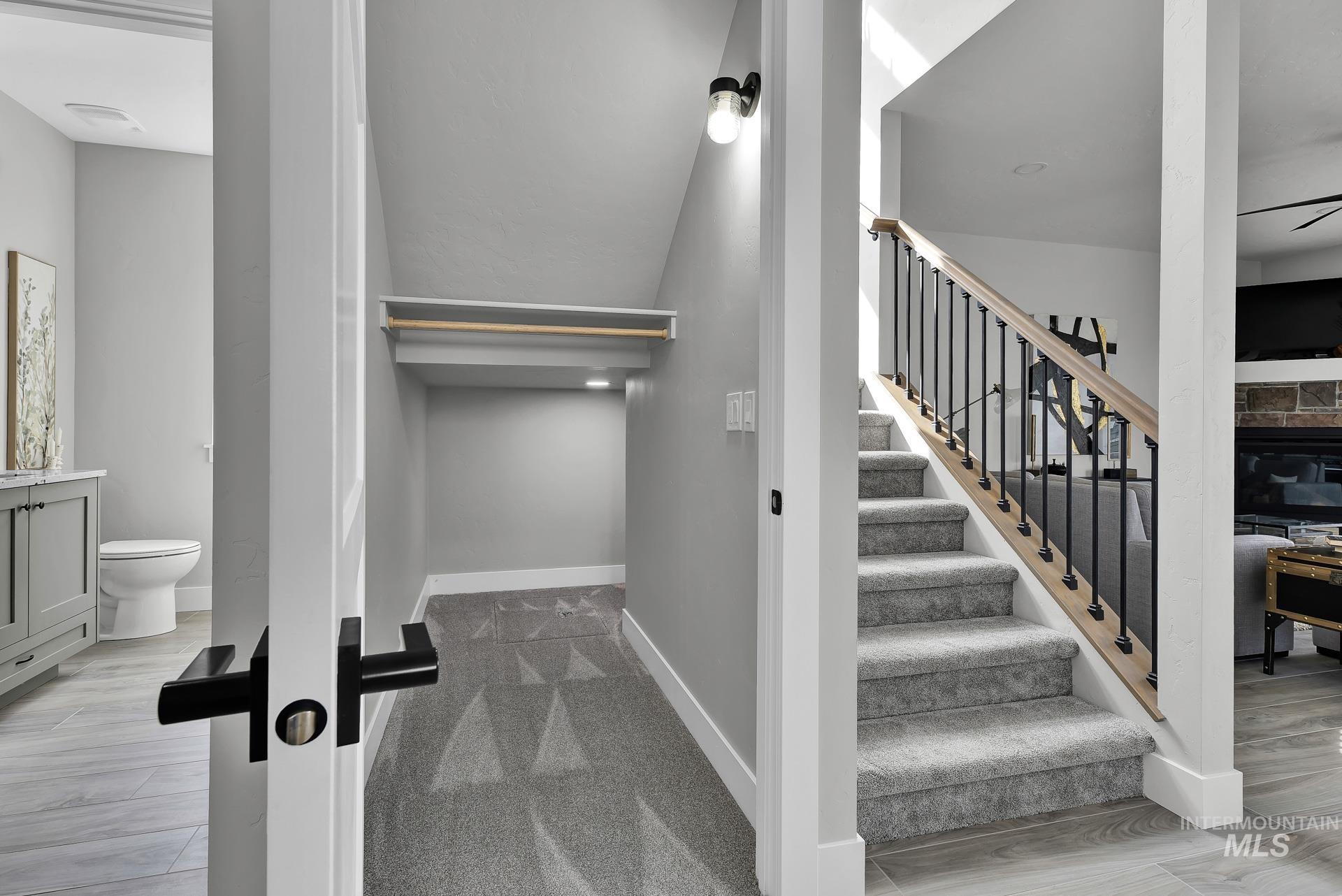 Stairs featuring wood finished floors