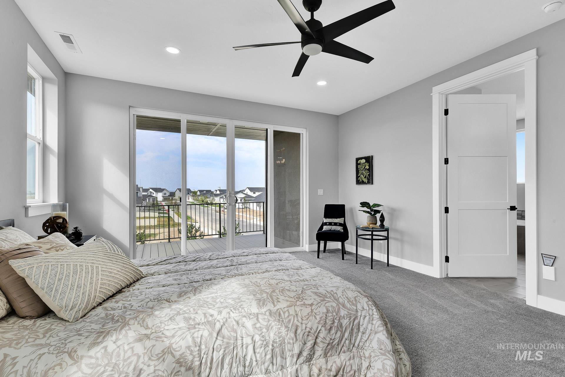 Bedroom featuring multiple windows, recessed lighting, a ceiling fan, carpet, and access to outside