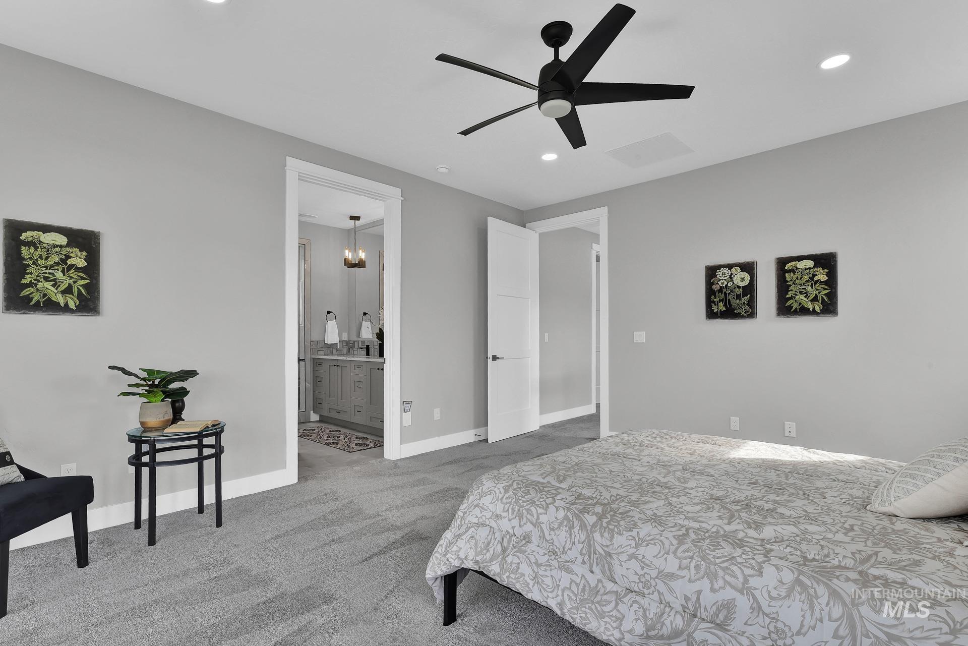 Bedroom featuring light carpet, recessed lighting, a ceiling fan, and ensuite bathroom