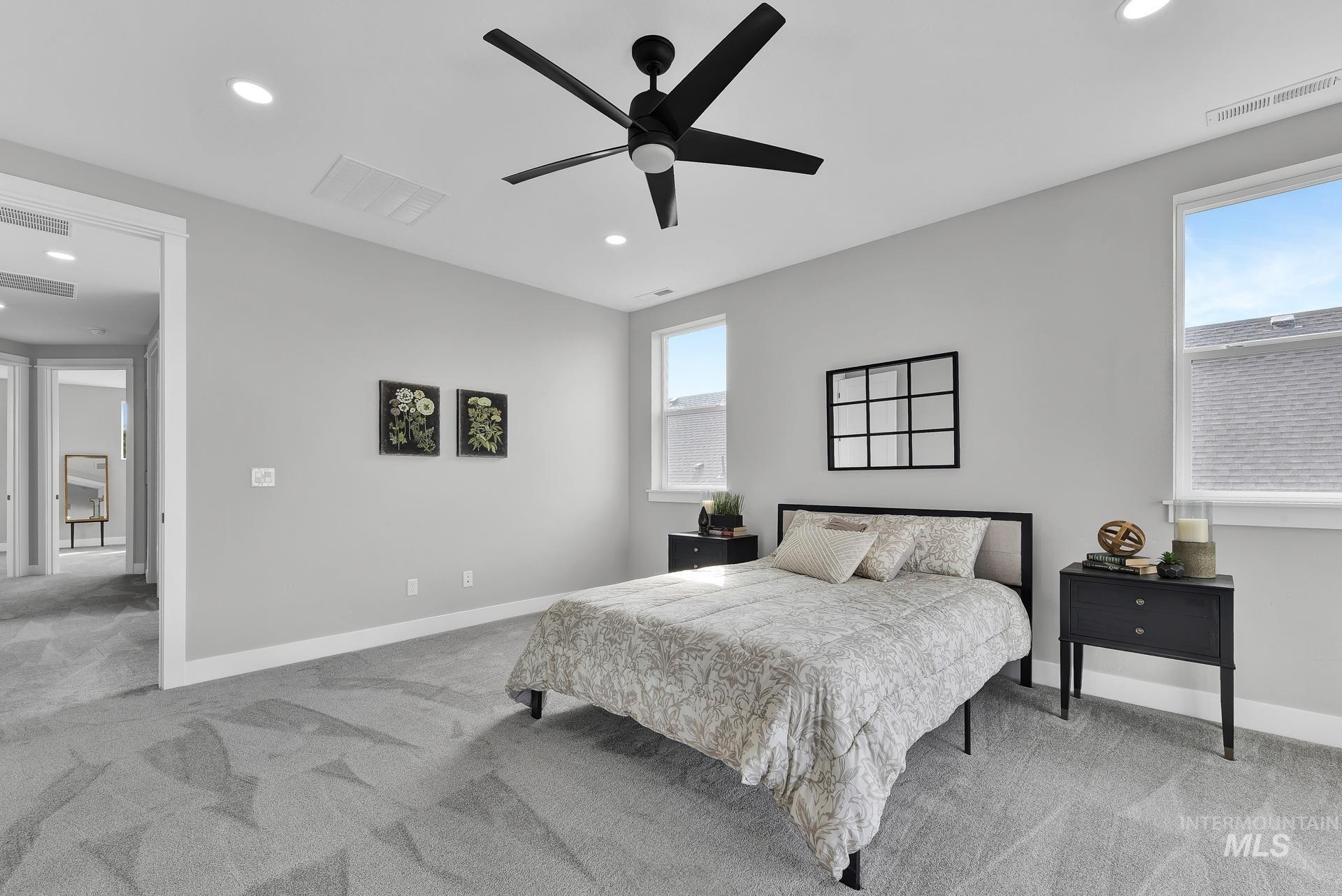 Bedroom with light colored carpet, recessed lighting, and ceiling fan