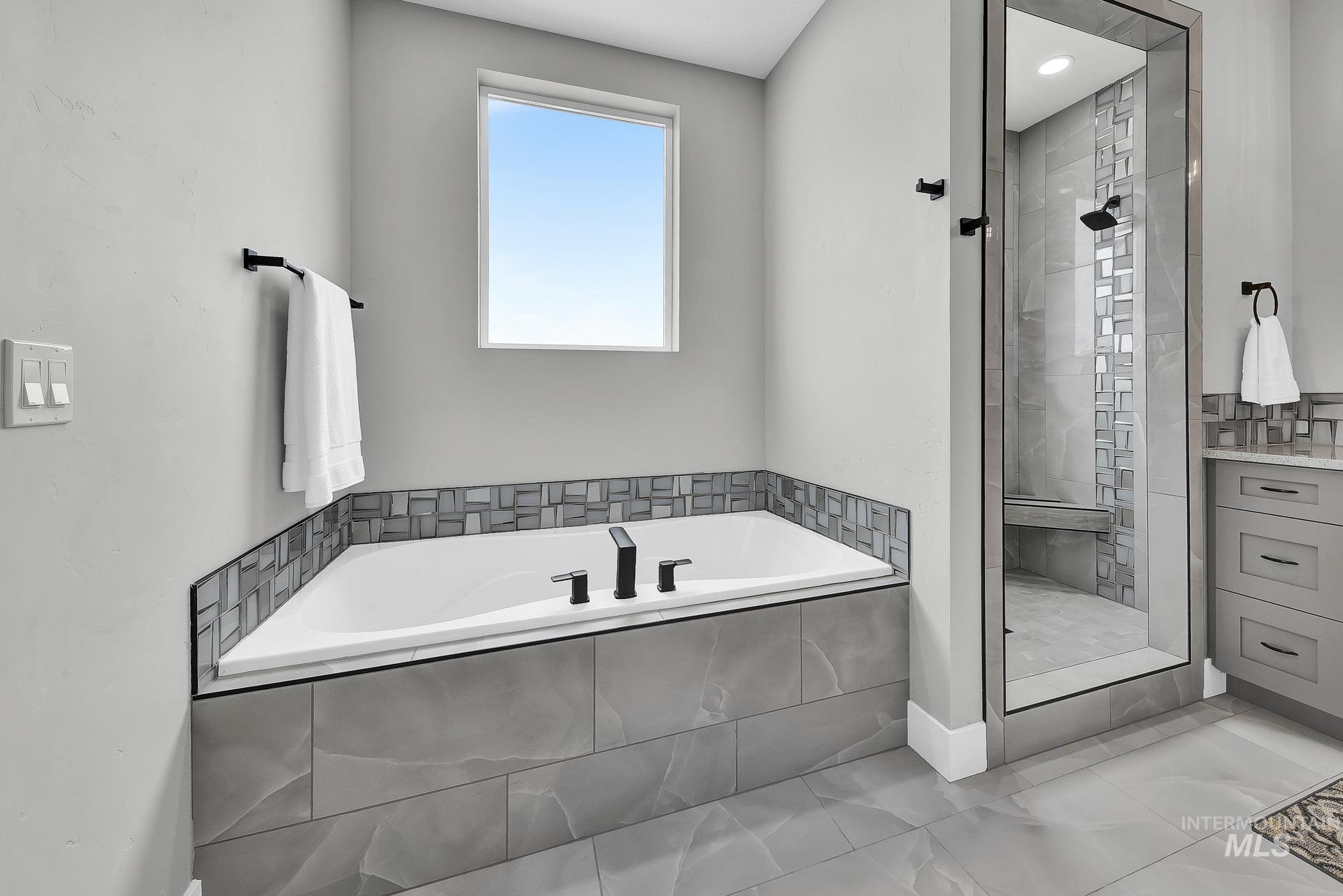 Full bathroom with a bath and a shower stall