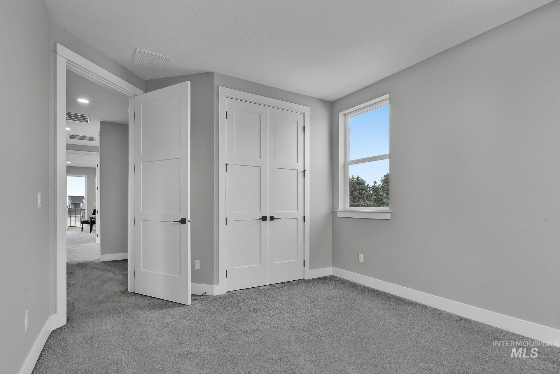 Unfurnished bedroom featuring carpet flooring and a closet