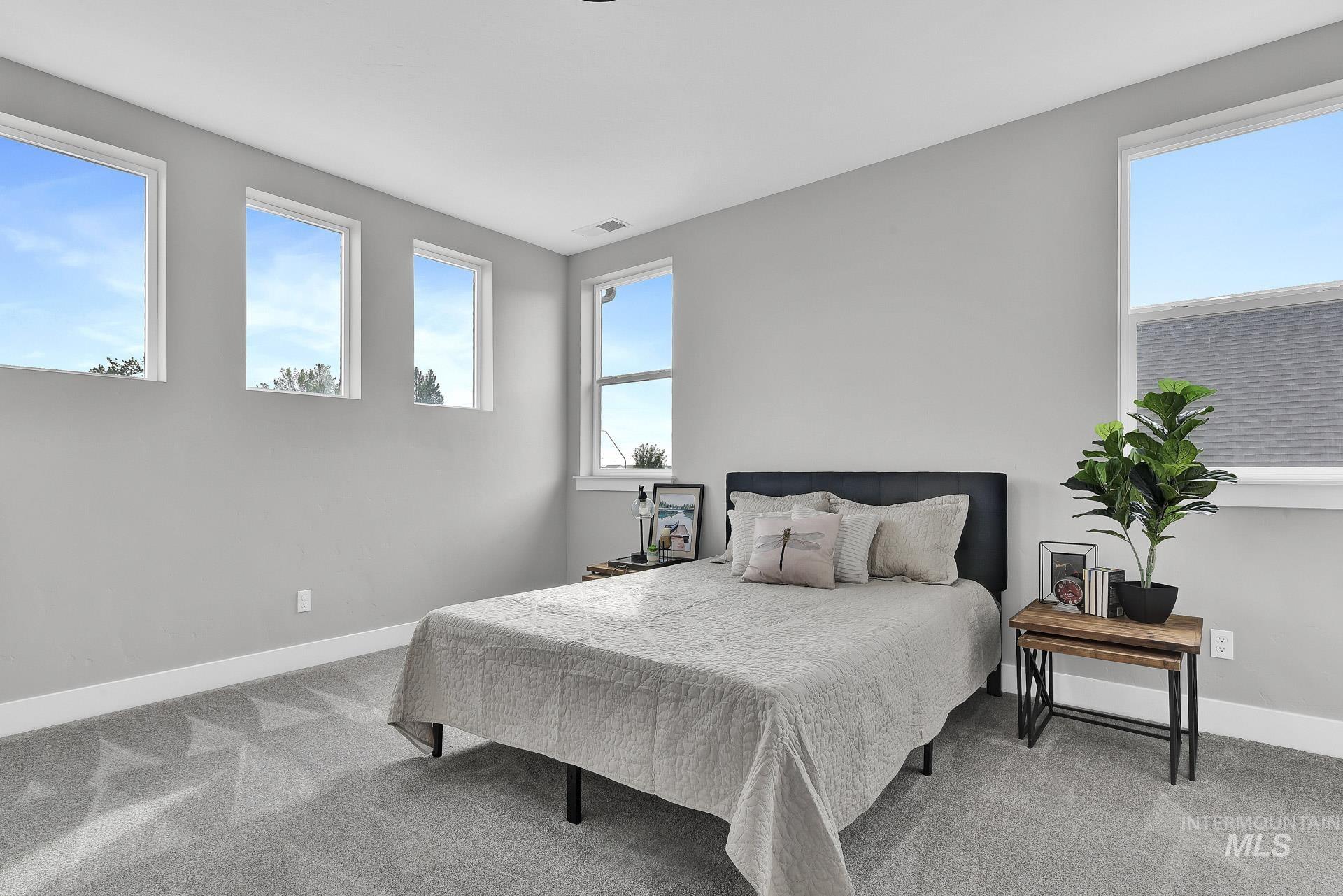 Bedroom featuring carpet floors and baseboards