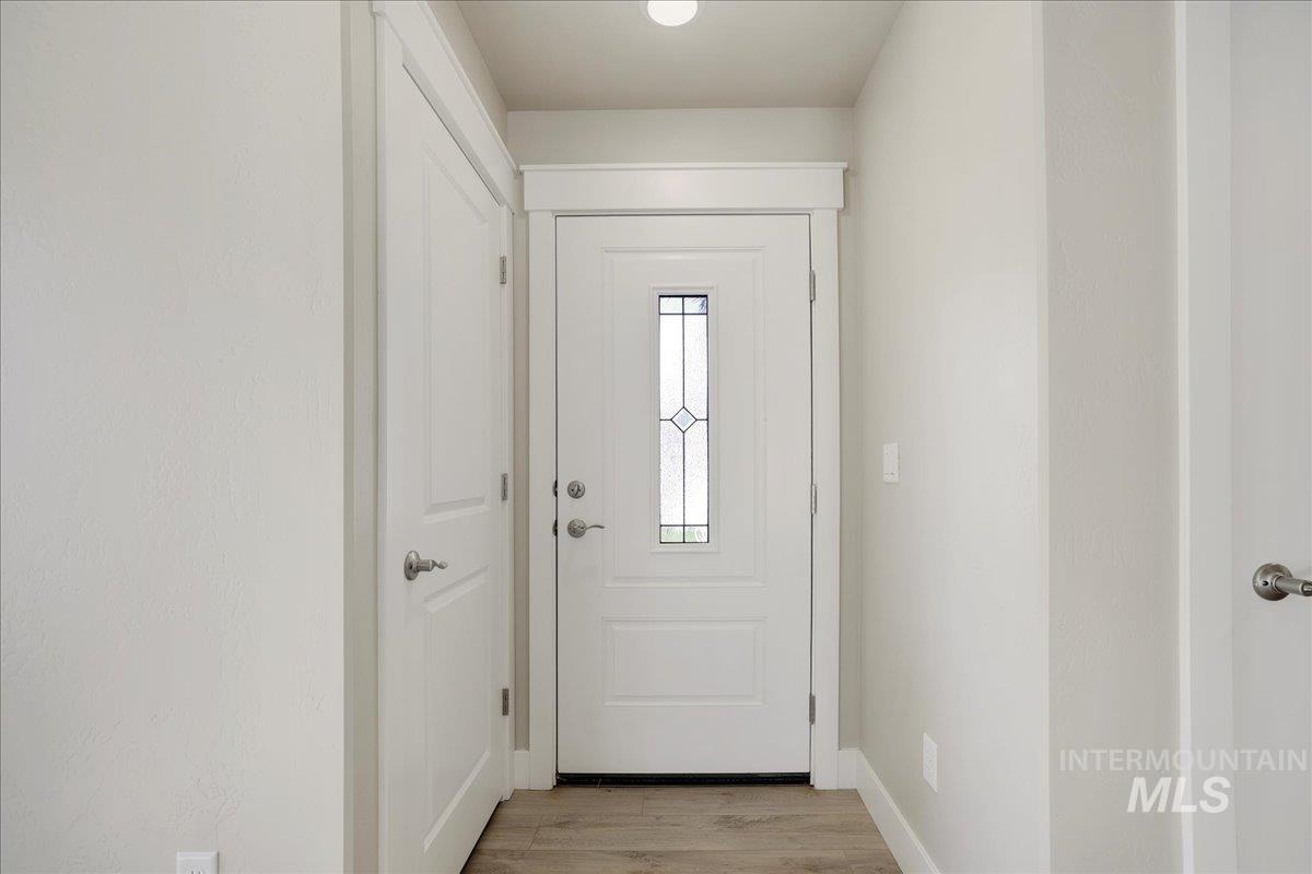 Entryway featuring light wood-style floors and baseboards