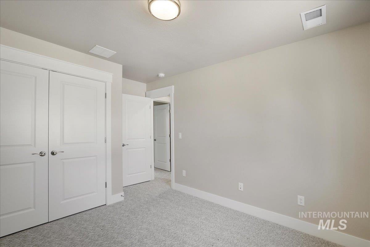 Unfurnished bedroom with carpet flooring and a closet