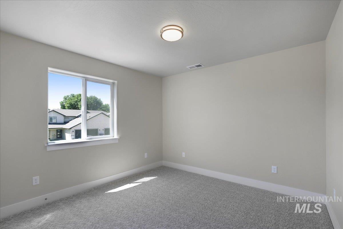 Unfurnished room with carpet floors and baseboards