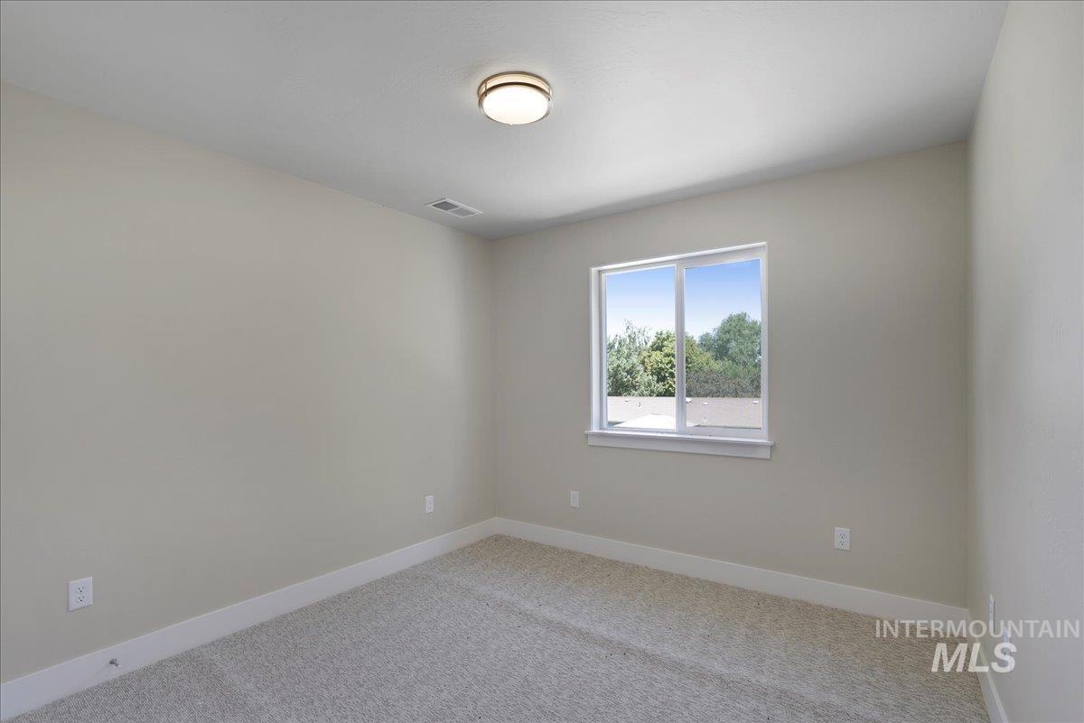 Unfurnished room featuring light carpet