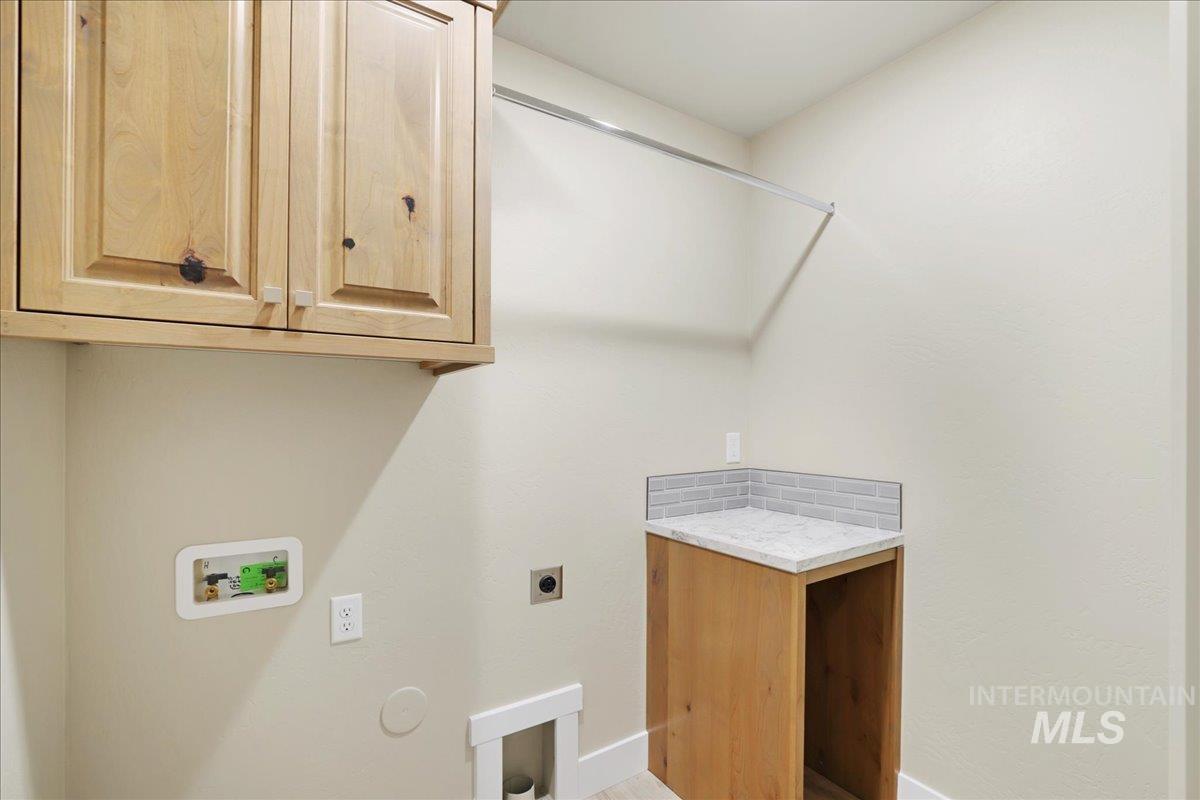 Laundry room featuring cabinet space, electric dryer hookup, hookup for a washing machine, and hookup for a gas dryer
