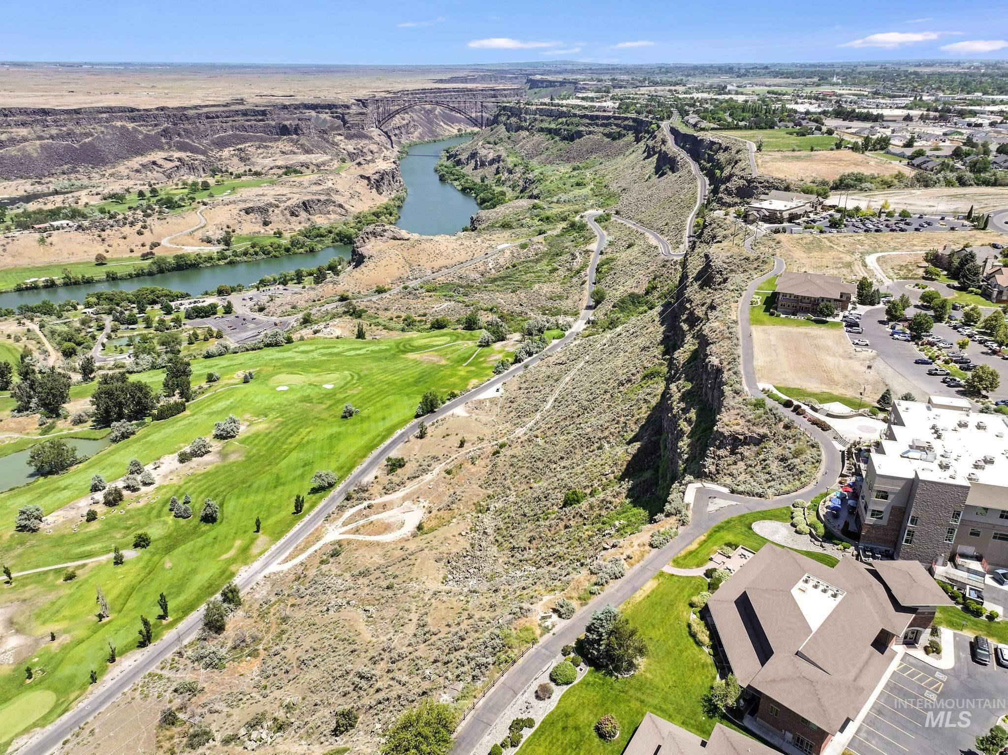 Aerial view of residential area with a nearby body of water and a local golf course