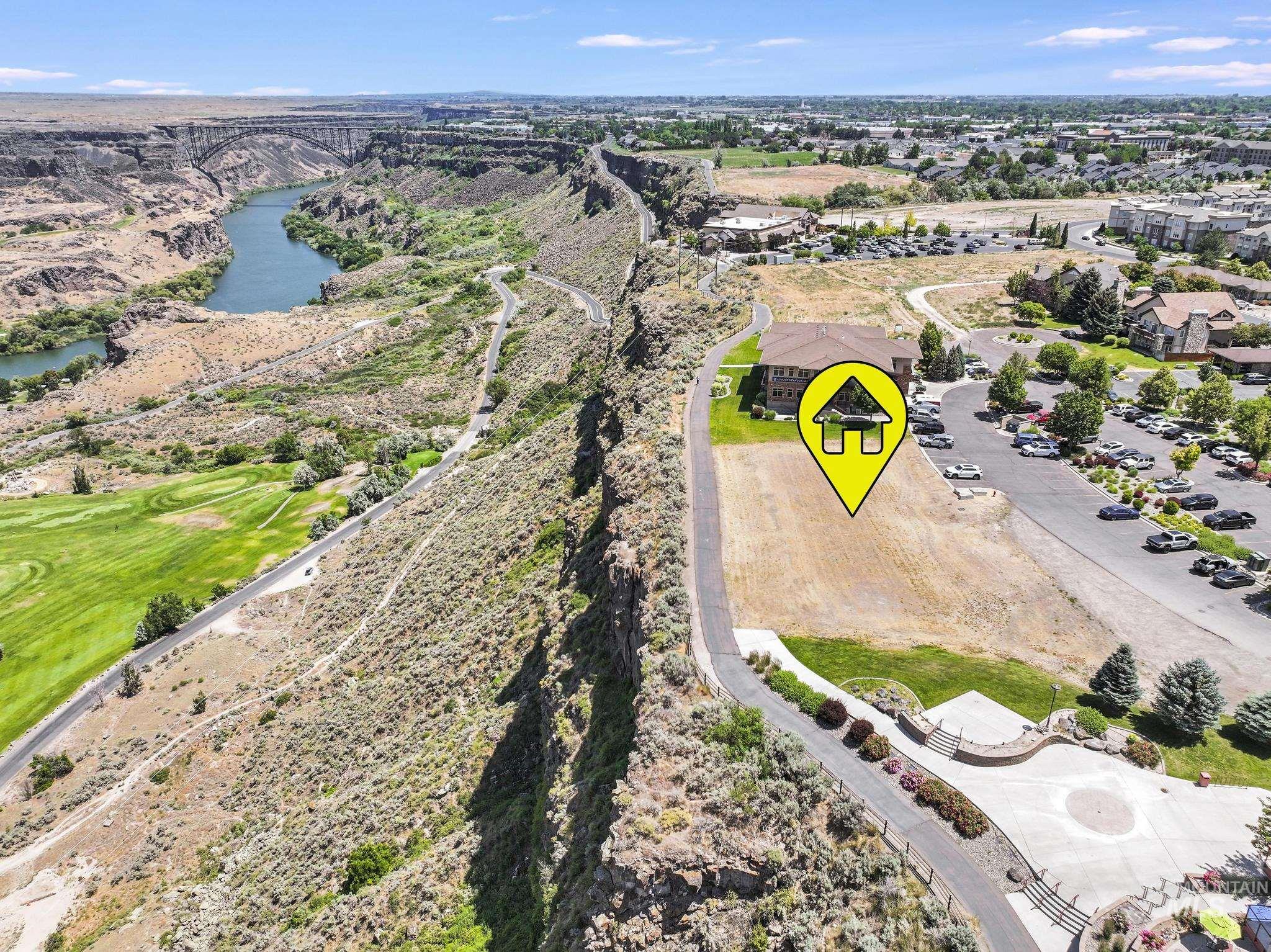 Bird's eye view of a nearby body of water and a local golf course