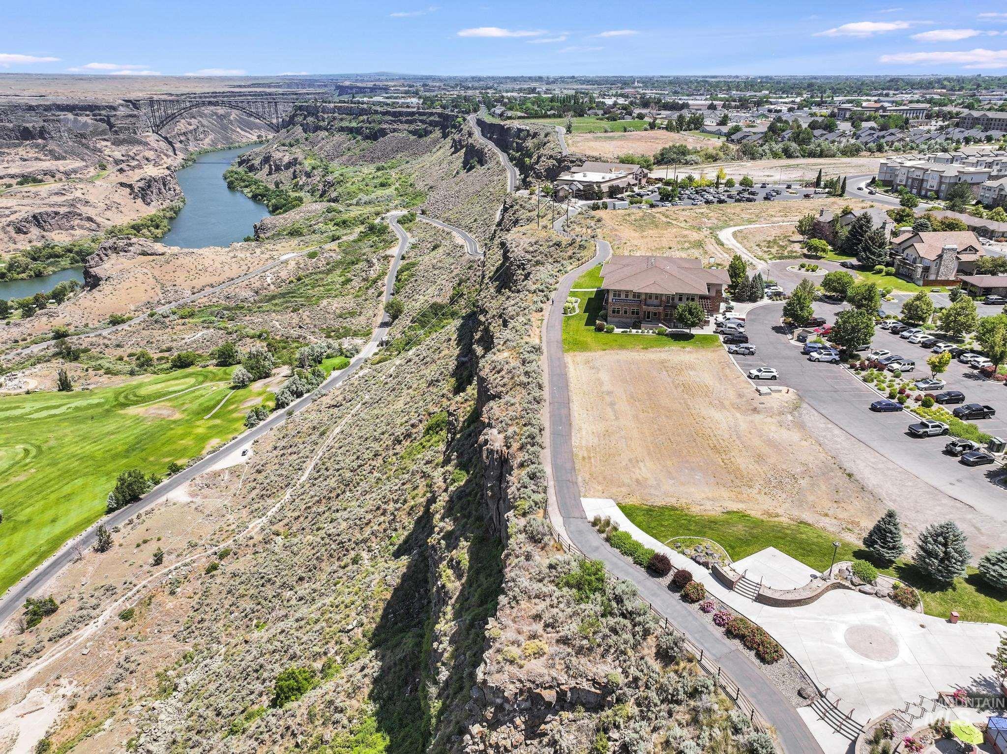 Bird's eye view of a nearby body of water and a local golf course