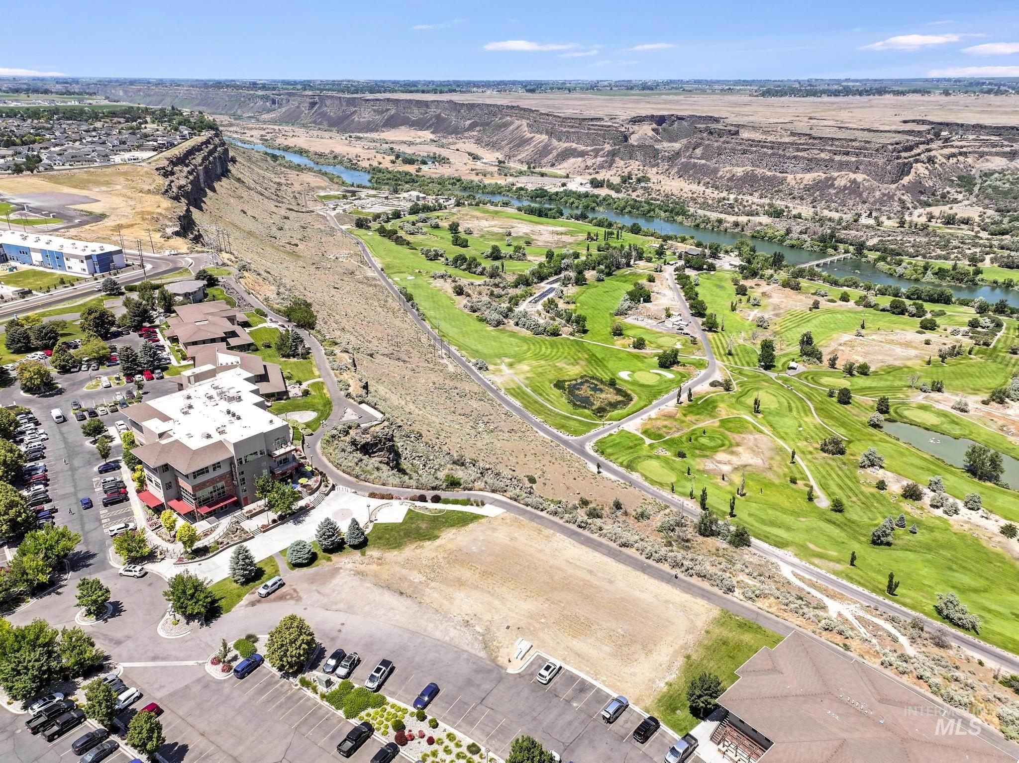 Bird's eye view of a large body of water and a local golf course