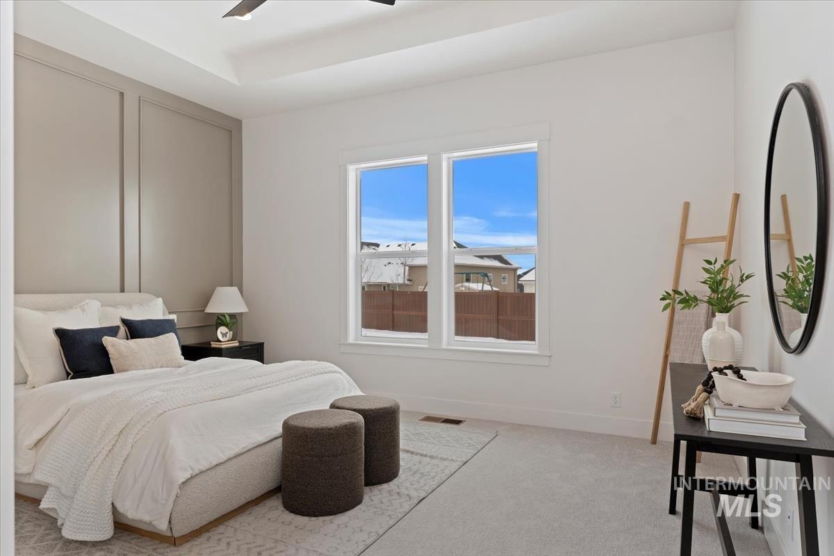 Bedroom featuring light carpet and a ceiling fan