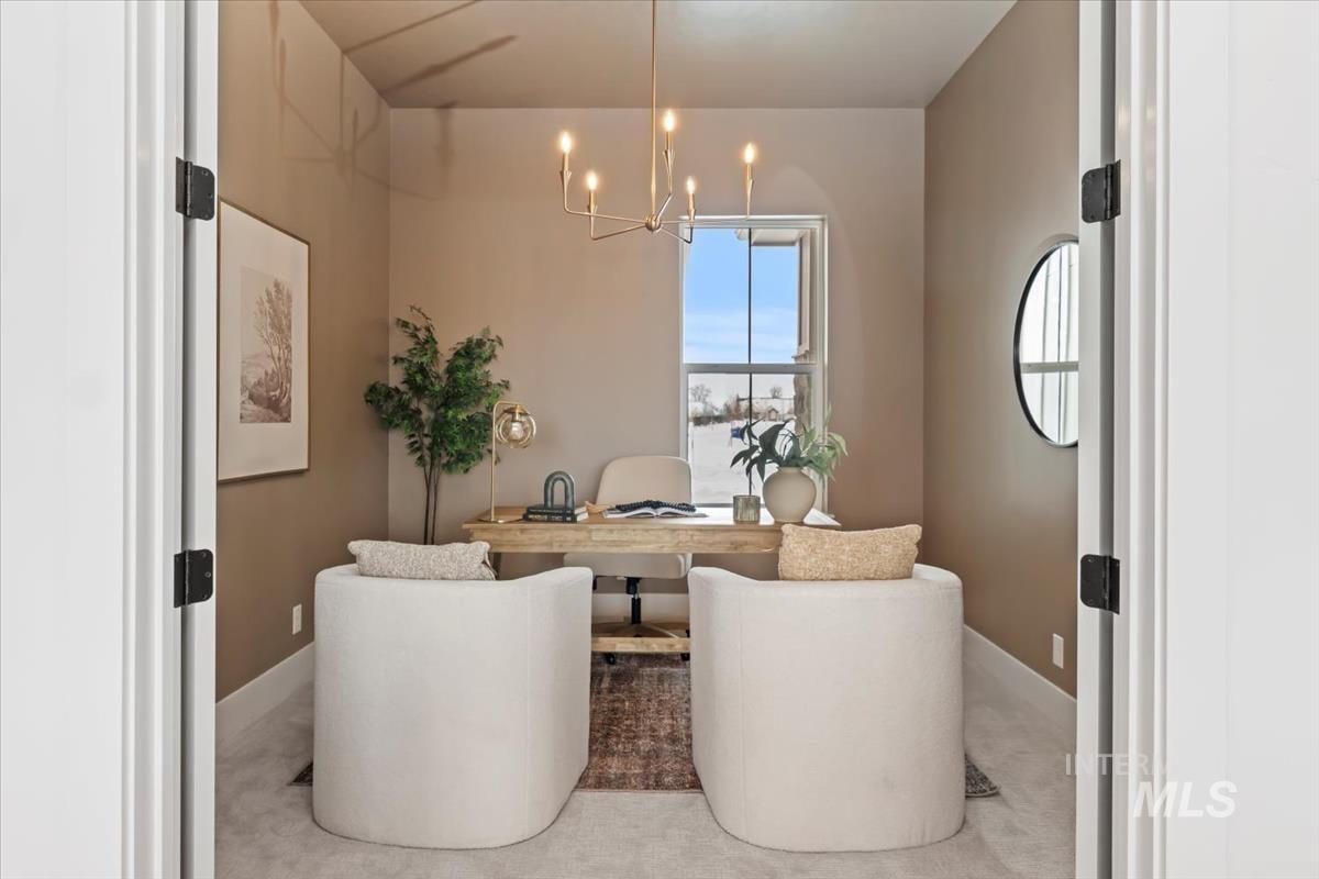 Office space featuring a chandelier and carpet floors