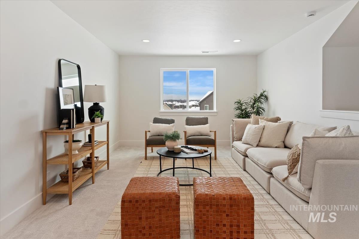 Living room with light carpet and recessed lighting