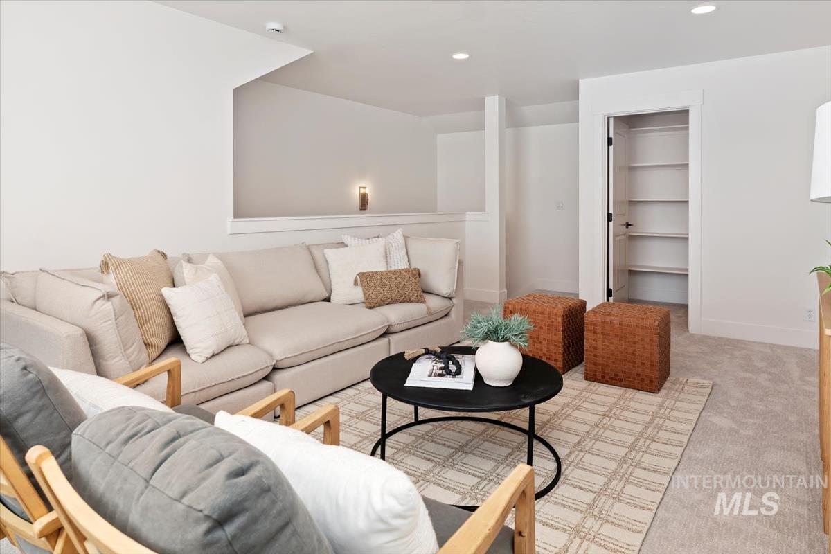 Living room with light colored carpet and recessed lighting