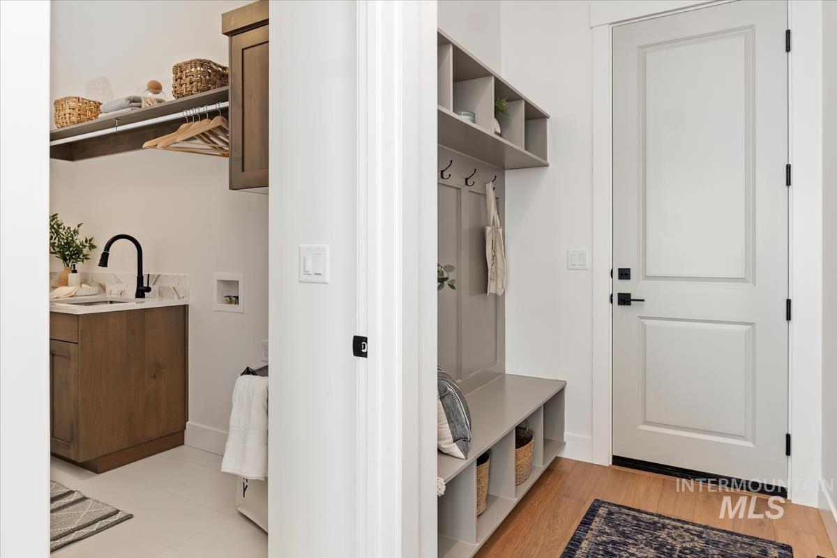 Mudroom featuring a sink and light wood-style flooring