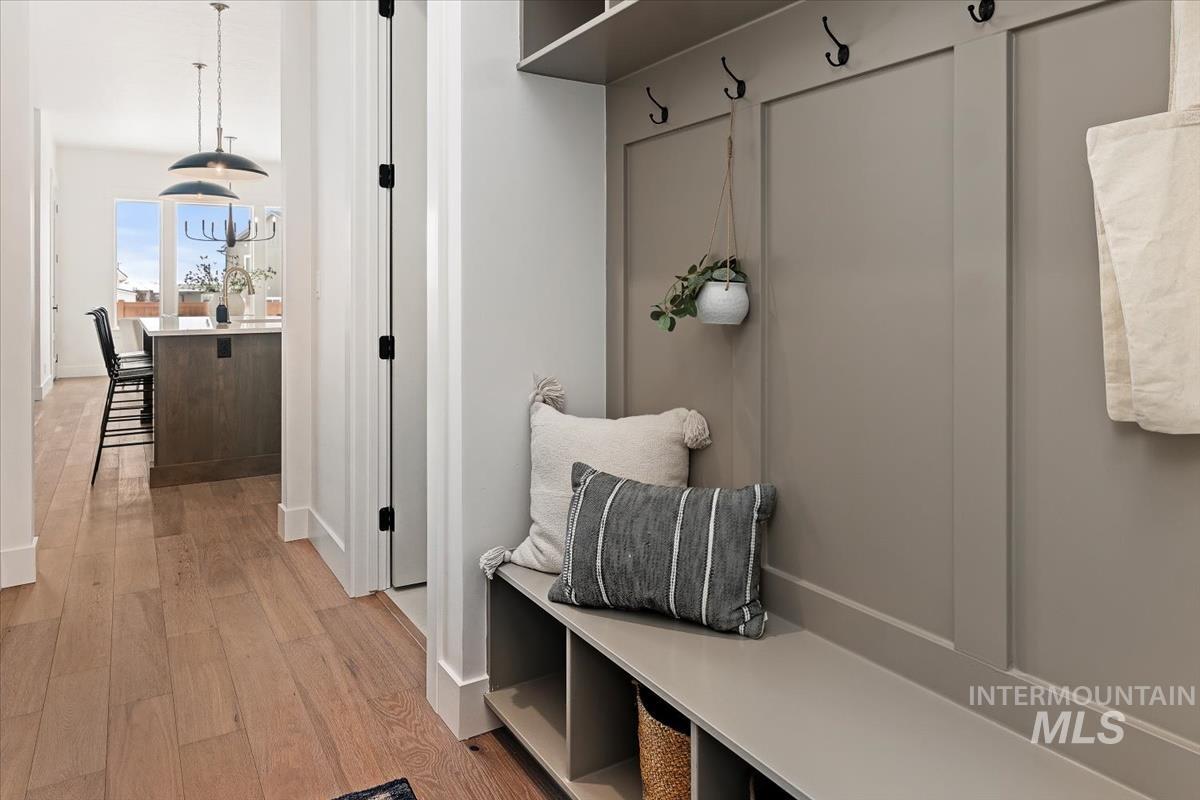 Mudroom with light wood-type flooring and baseboards
