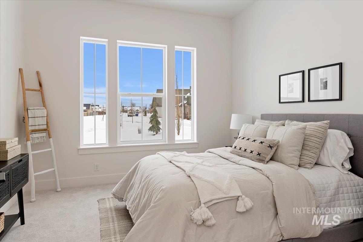 Carpeted bedroom with baseboards