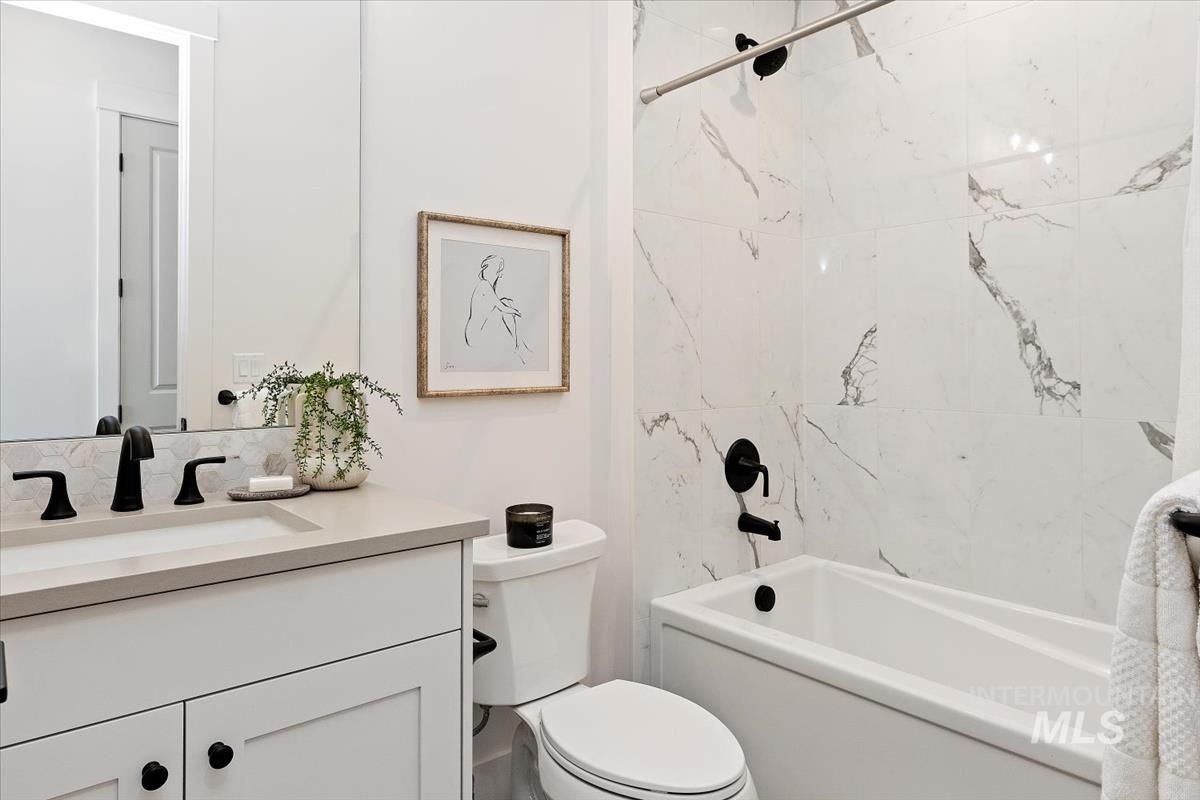 Bathroom with vanity and tub / shower combination