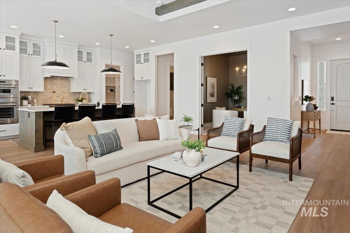 Living area with recessed lighting and light wood-type flooring