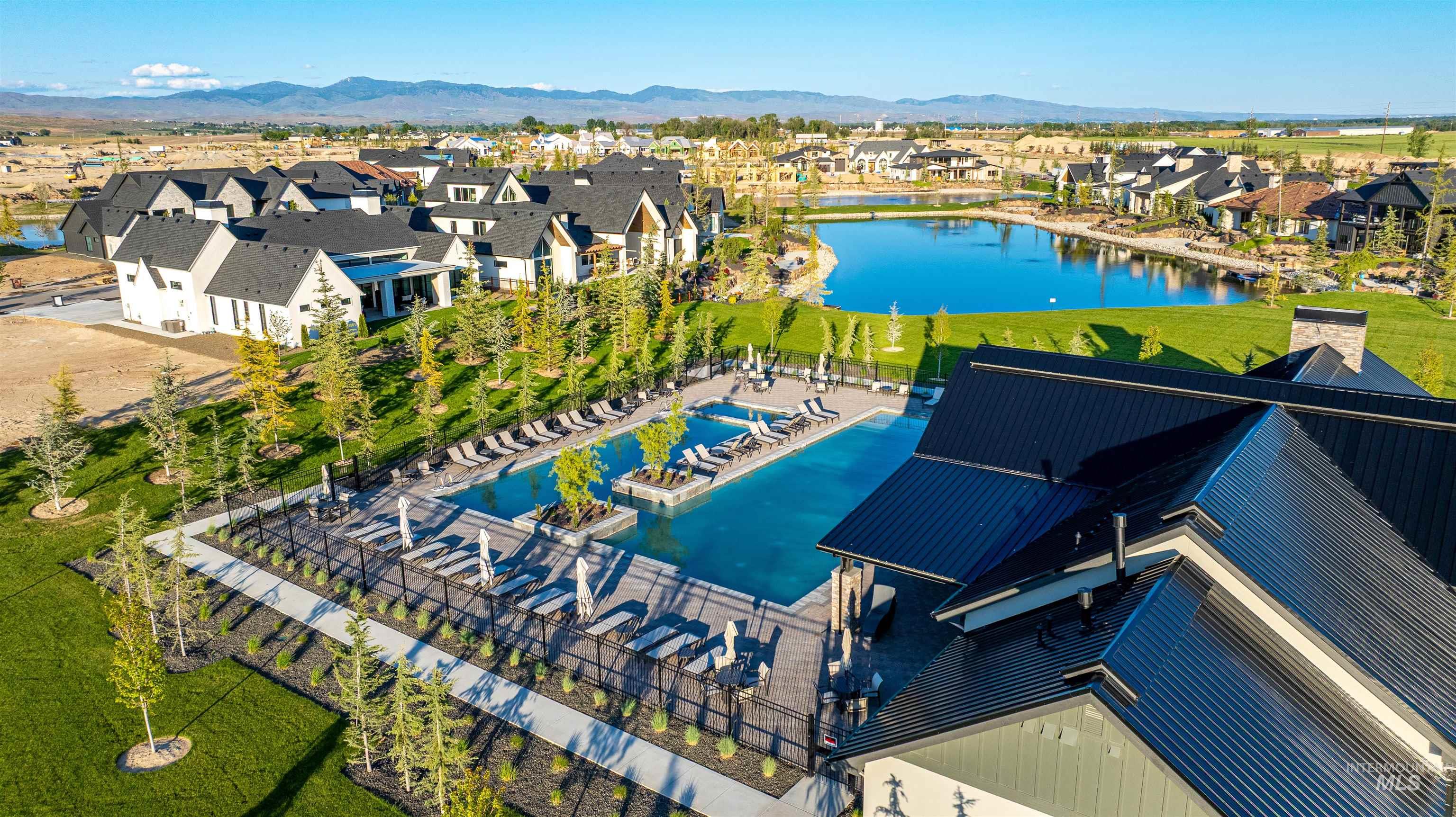 Aerial perspective of suburban area featuring a water and mountain view