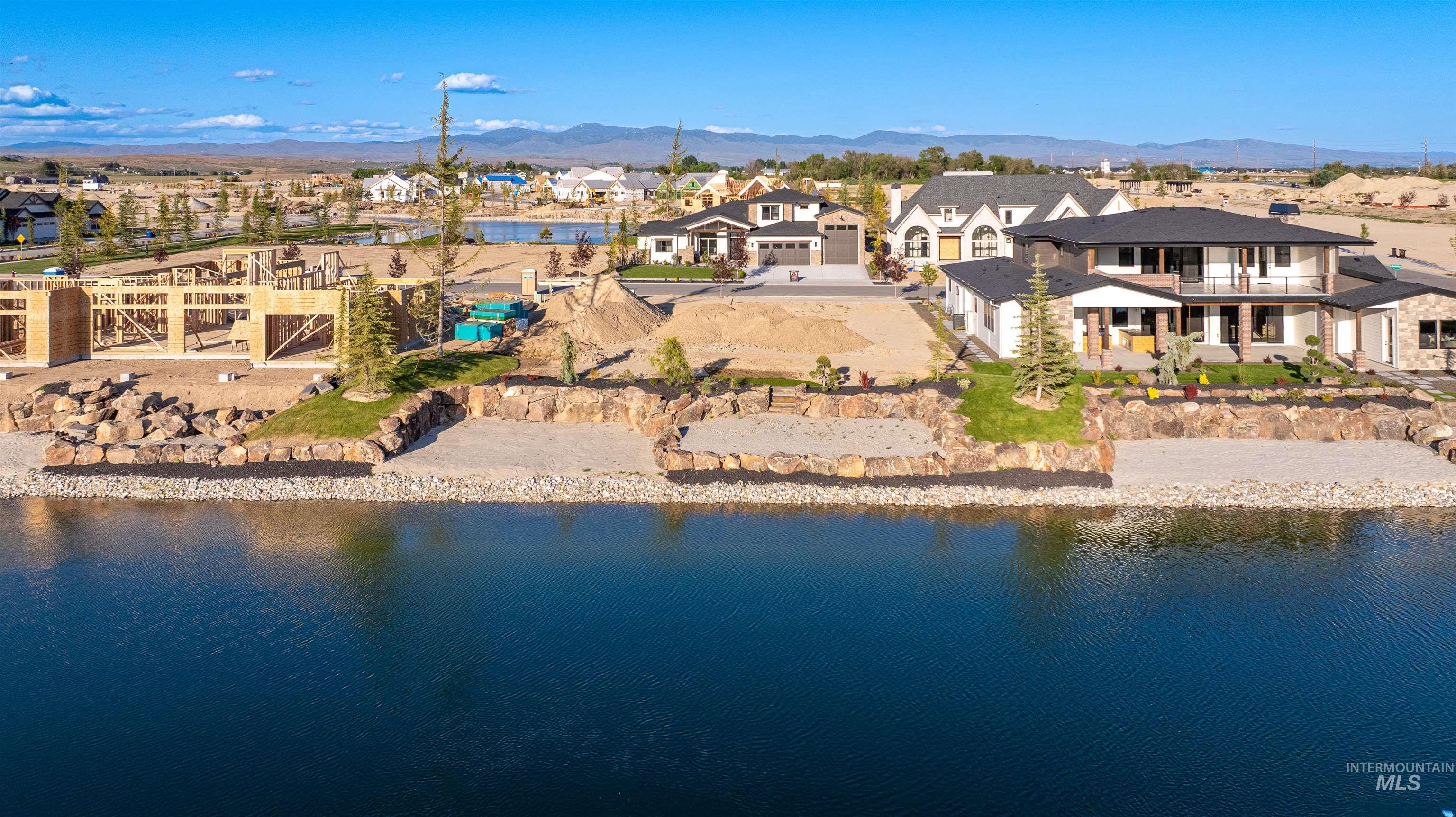 Aerial view of residential area featuring a water and mountain view