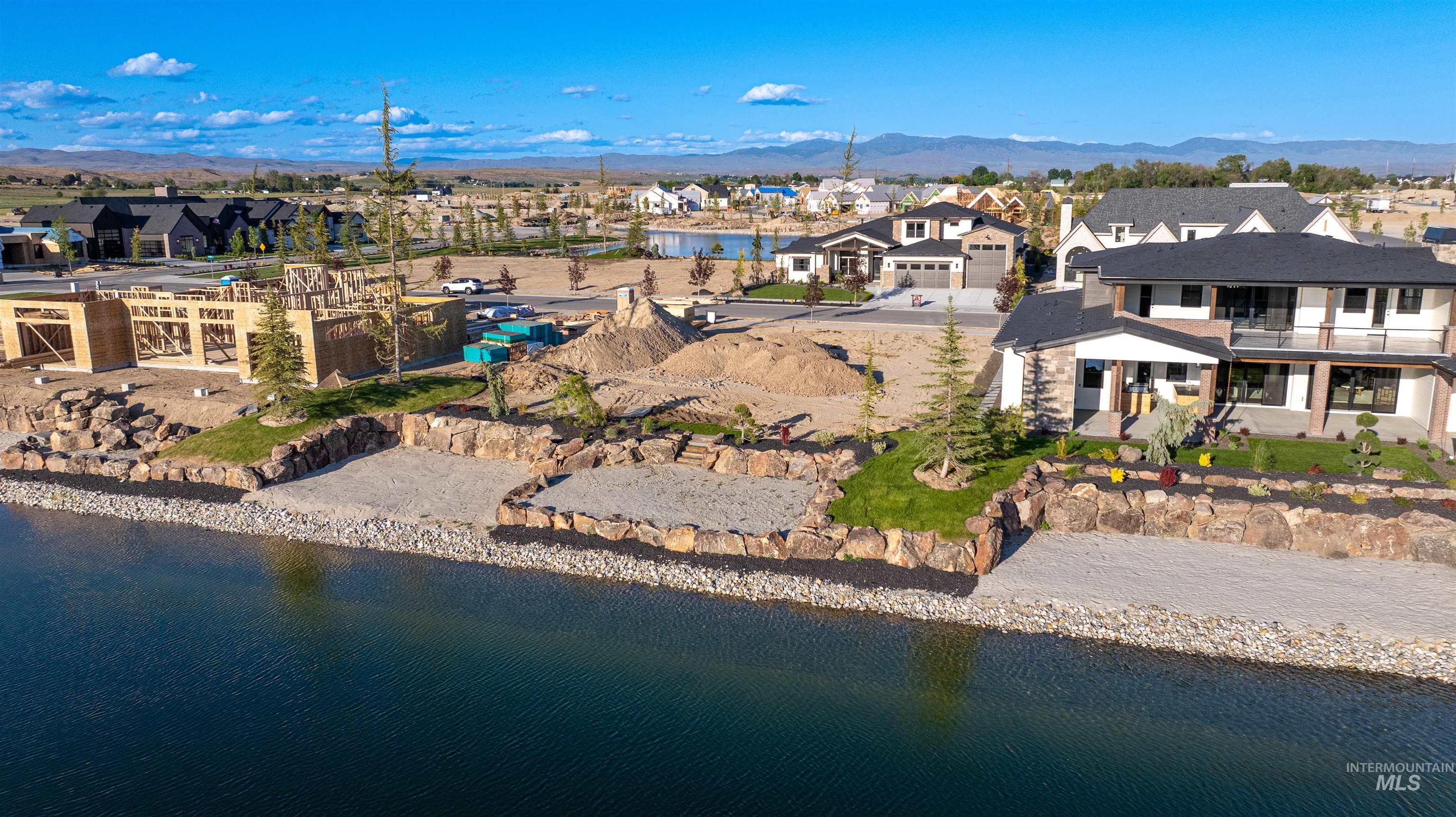 Aerial view of property's location featuring nearby suburban area and a water and mountain view