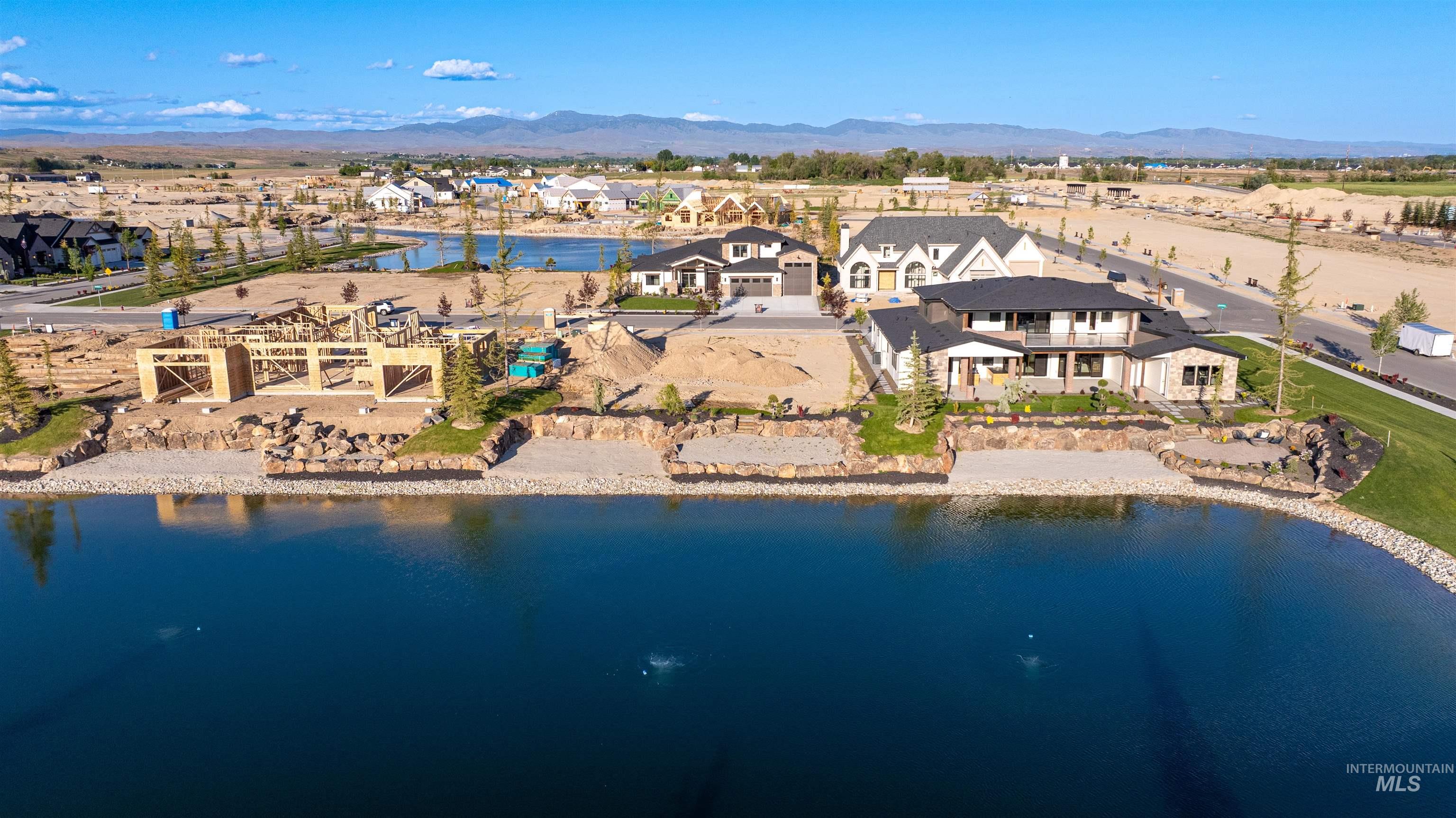 Aerial perspective of suburban area with a water and mountain view