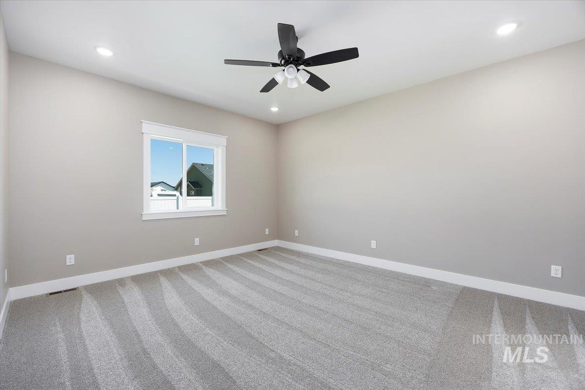 Spare room featuring carpet, recessed lighting, and a ceiling fan