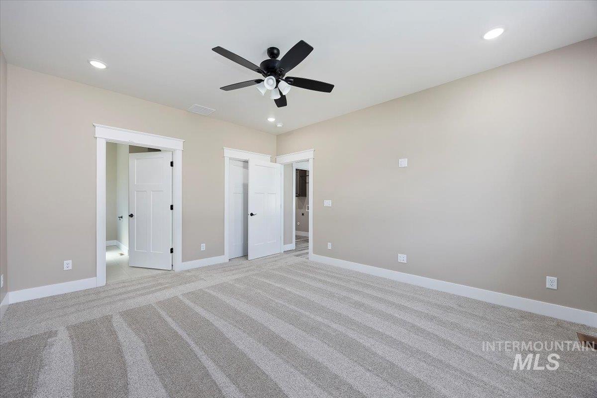 Unfurnished bedroom with recessed lighting, light colored carpet, and a ceiling fan