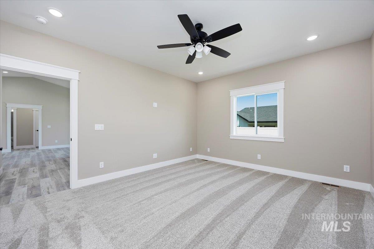 Unfurnished room with light carpet, recessed lighting, and a ceiling fan