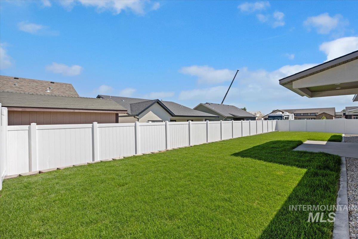 Fenced backyard with a residential view
