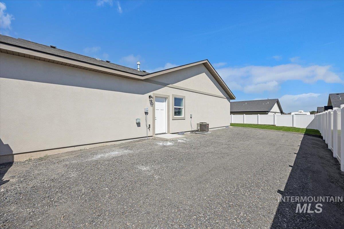 Rear view of property with a fenced backyard and stucco siding