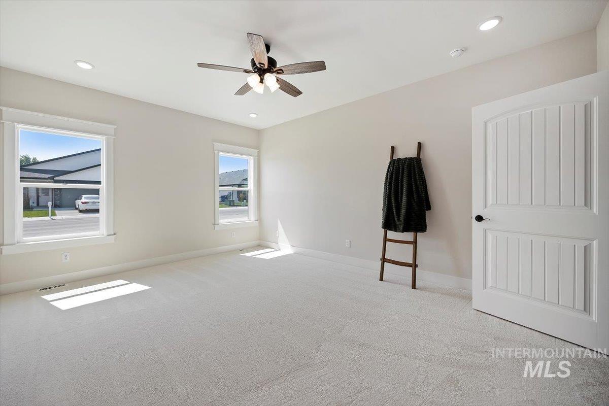 Unfurnished bedroom featuring carpet flooring, recessed lighting, and a ceiling fan