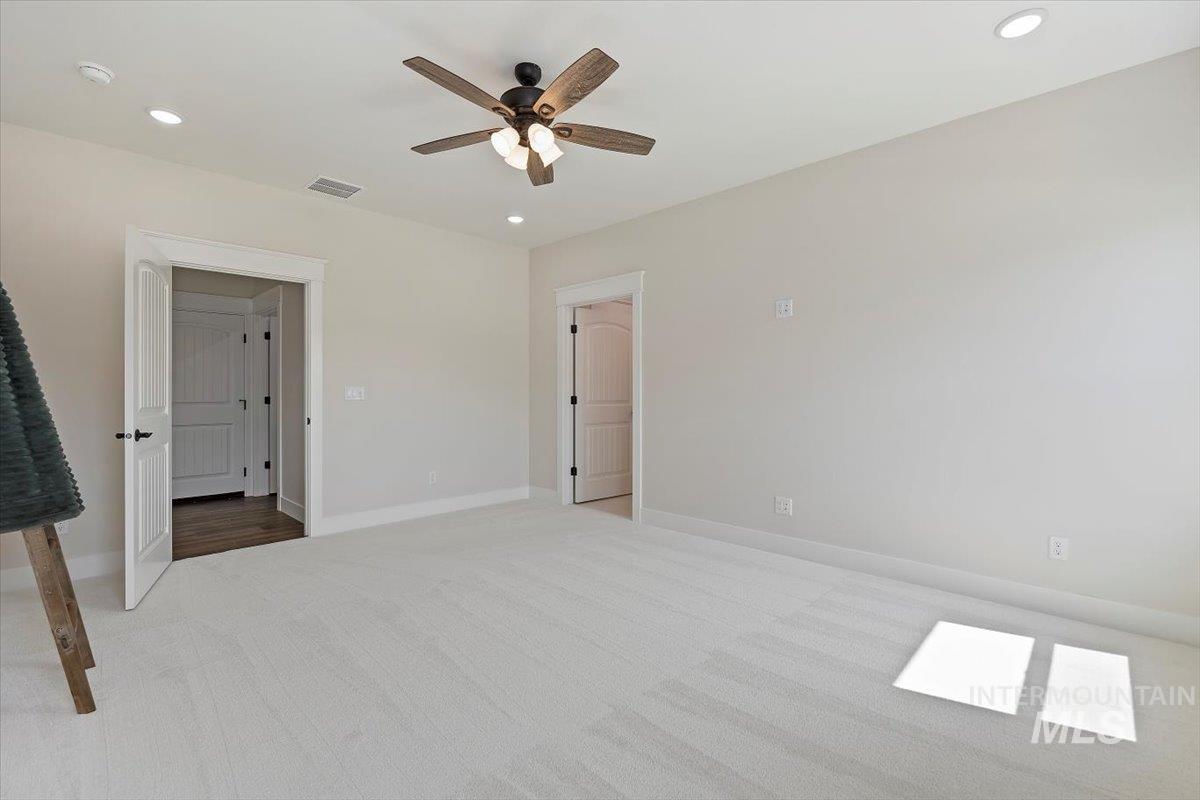 Unfurnished bedroom featuring recessed lighting, carpet, and a ceiling fan