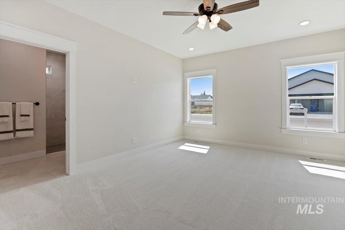 Unfurnished bedroom with light colored carpet, ceiling fan, and recessed lighting
