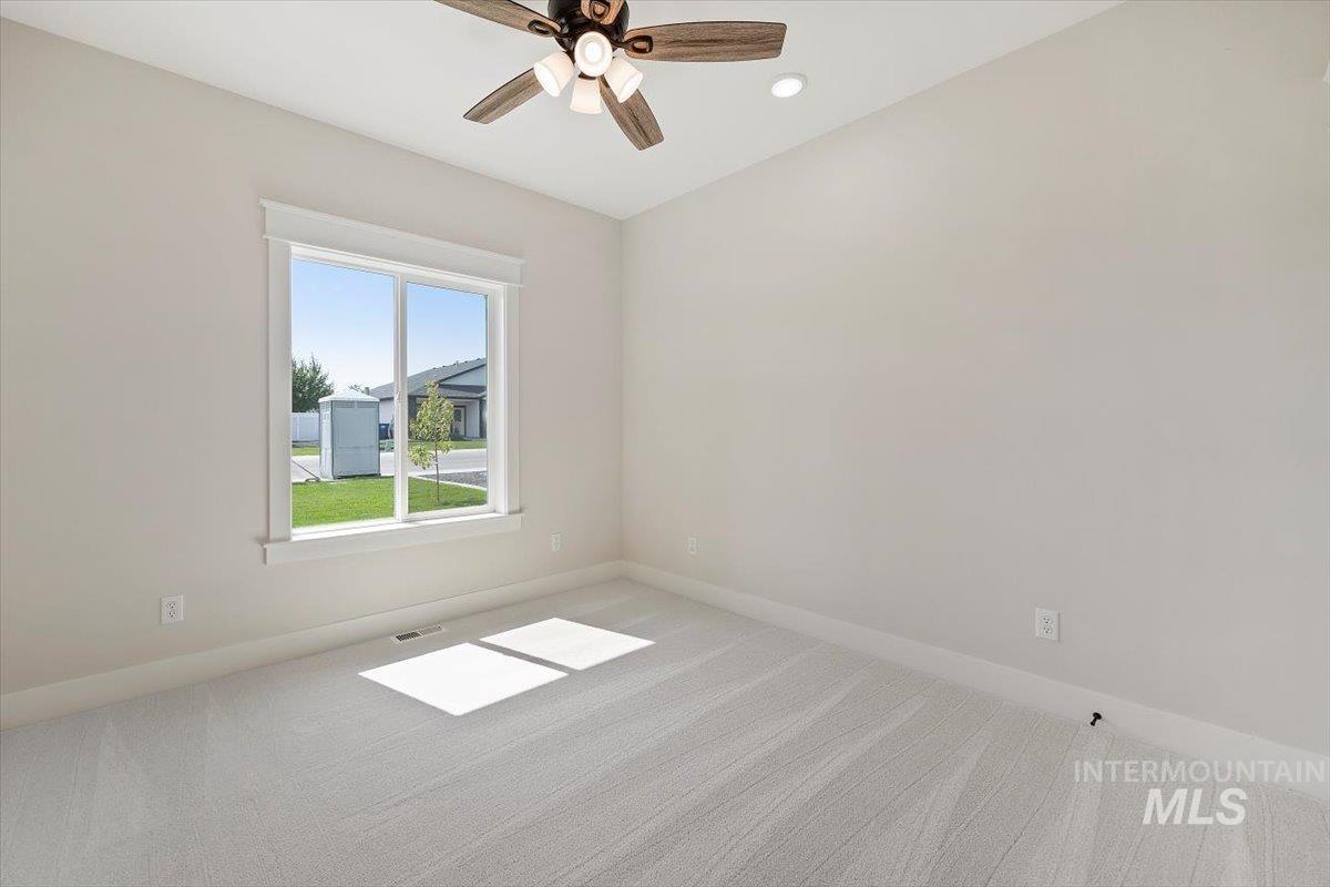 Spare room with carpet, ceiling fan, and recessed lighting
