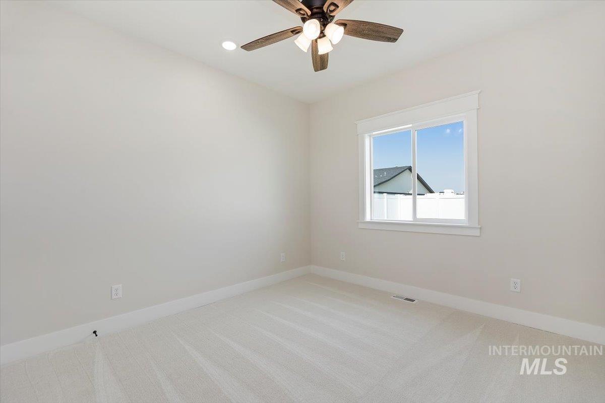 Unfurnished room with light colored carpet, recessed lighting, and a ceiling fan