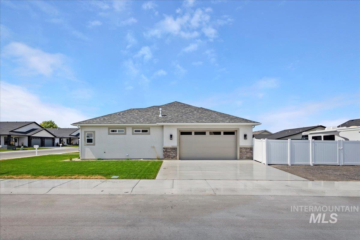 View of front of property with stucco siding, concrete driveway, a garage, and stone siding