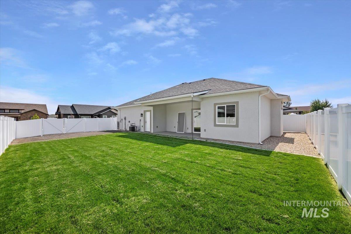 Rear view of house featuring a patio area, a fenced backyard, and stucco siding