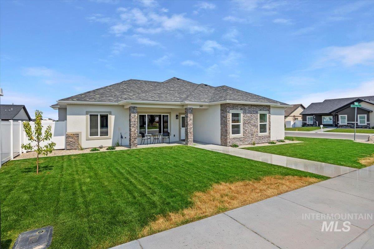 View of front of home with stucco siding and stone siding