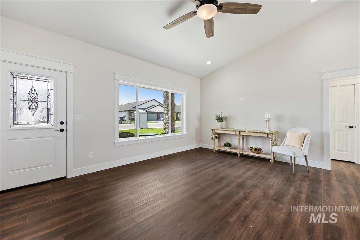 Entrance foyer with dark wood-style flooring, ceiling fan, high vaulted ceiling, and recessed lighting