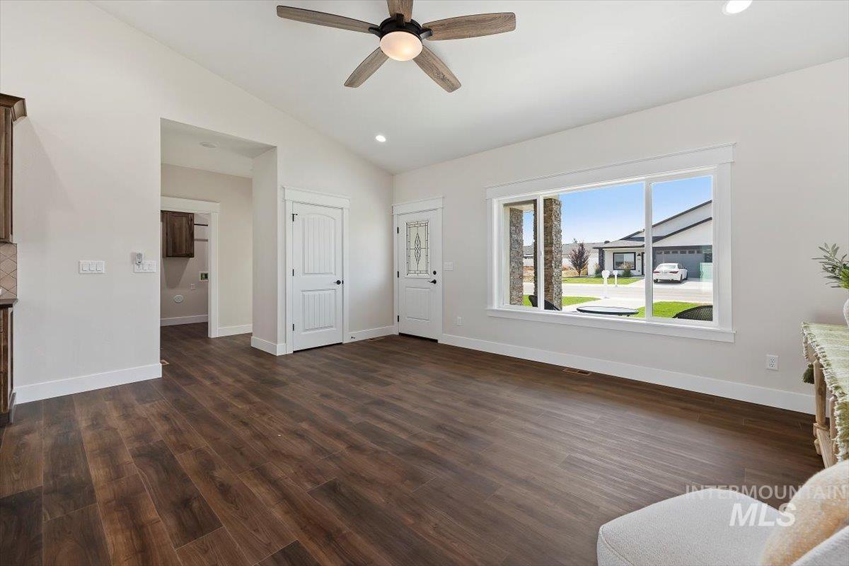 Living area featuring recessed lighting, vaulted ceiling, dark wood finished floors, and a ceiling fan