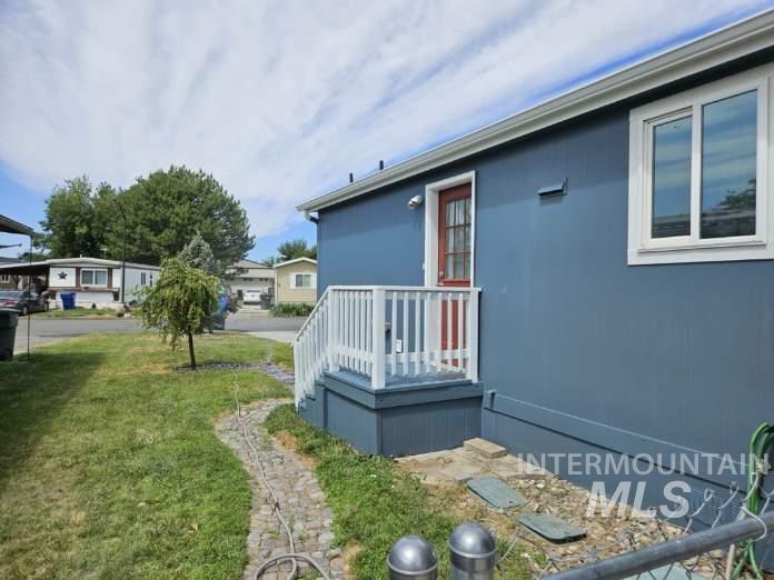 View of property exterior with a yard