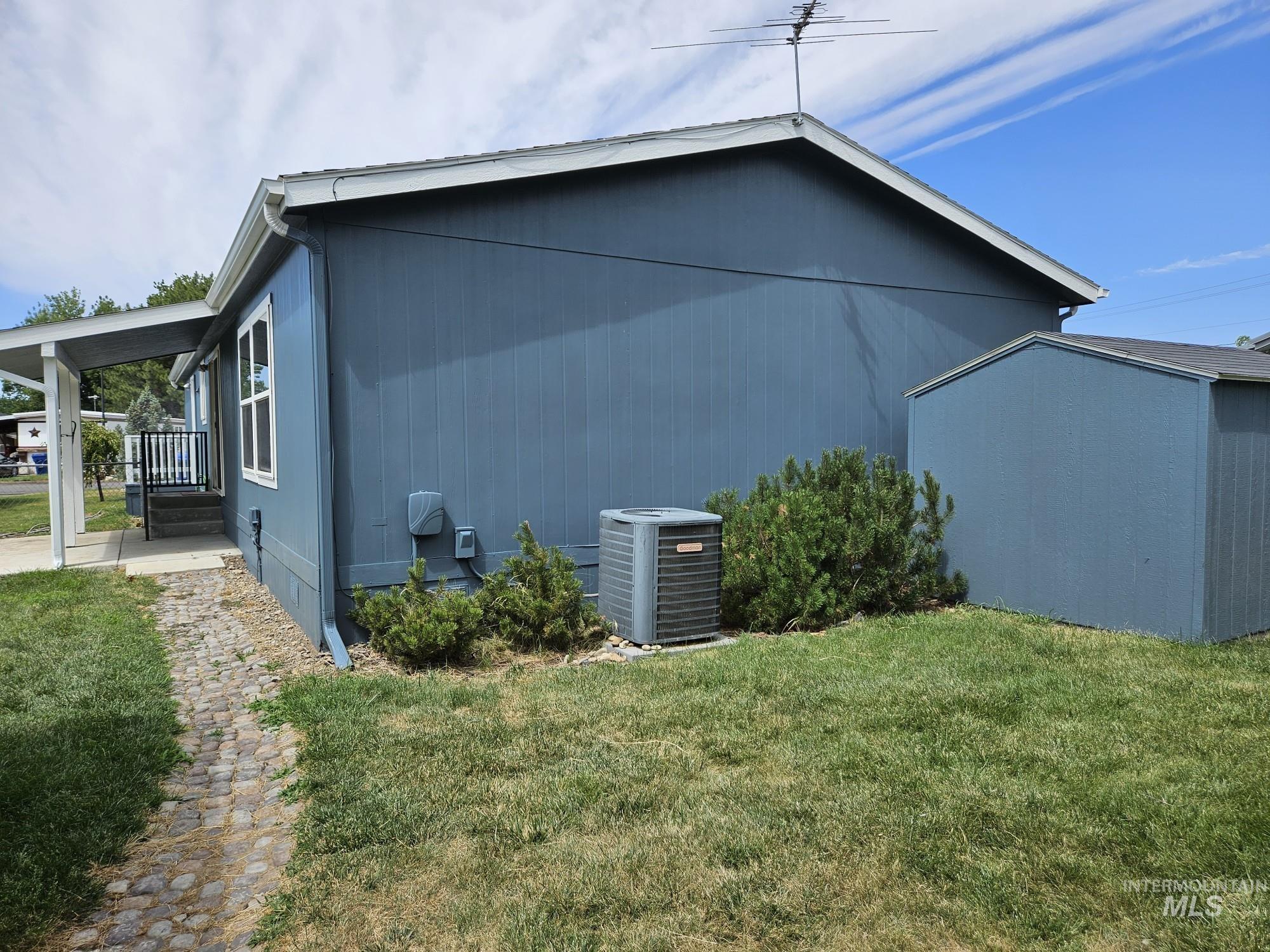 View of property exterior with a yard