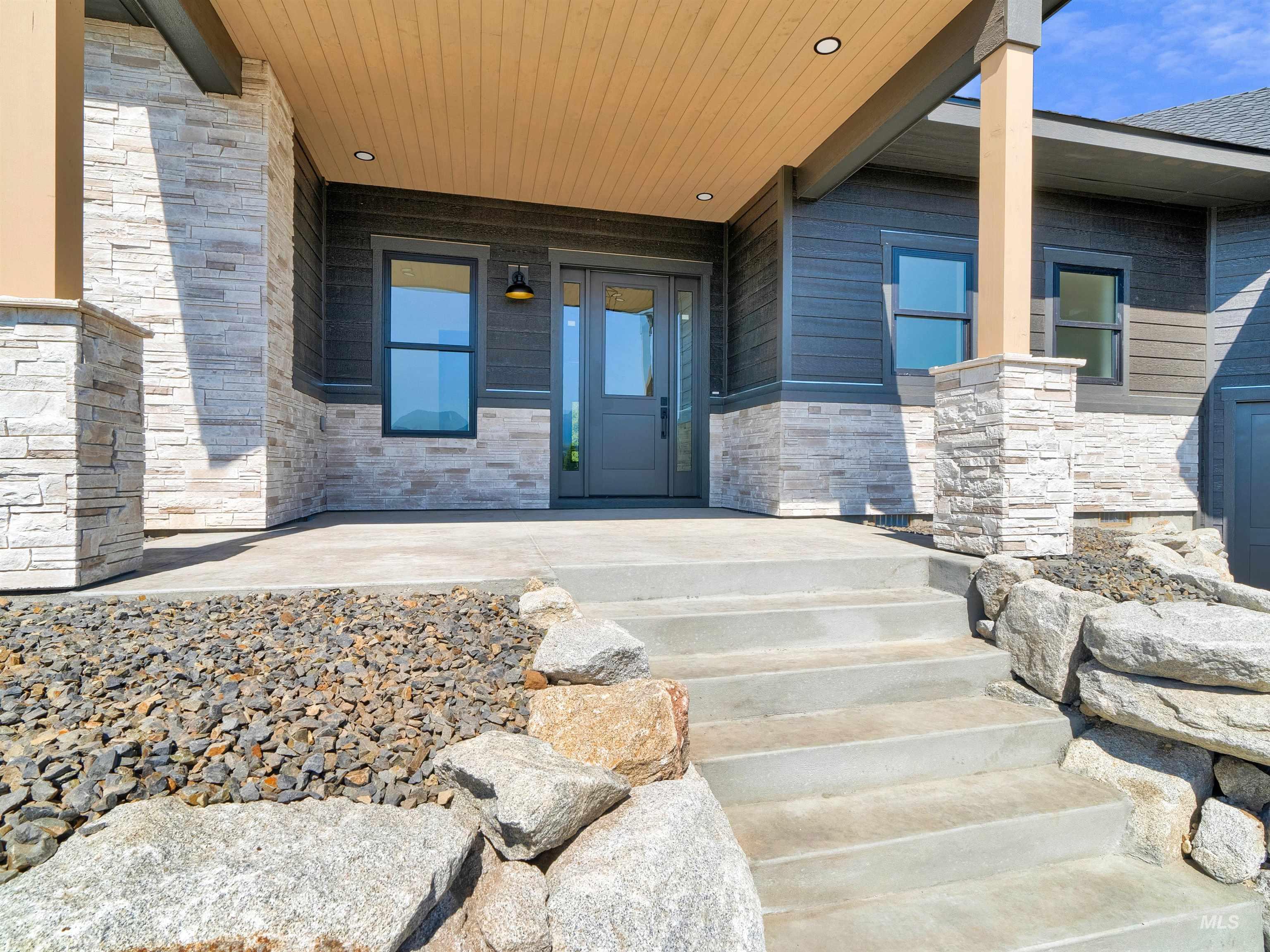 Property entrance with a porch and stone siding